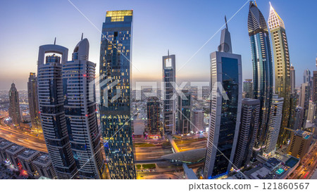 Skyline view of the buildings of Sheikh Zayed Road and DIFC day to night timelapse in Dubai, UAE. Skyline view of the buildings of Sheikh Zayed Road and DIFC day to night timelapse in Dubai, UAE. 121860567