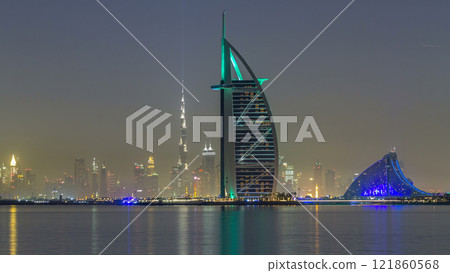 Skyline of Dubai by night with Burj Al Arab from the Palm Jumeirah timelapse hyperlapse. Skyline of Dubai by night with Burj Al Arab from the Palm Jumeirah timelapse hyperlapse. 121860568