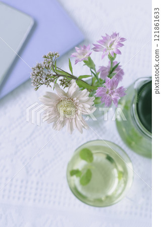 Flowers and mint tea on the table, vertical position 121861633