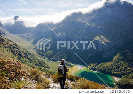 A girl climbing a mountain looking at Lake McKenzie 121861650