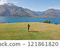 Woman looking out over Lake Wakatipu in New Zealand 121861820