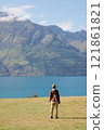 Woman looking out over Lake Wakatipu in New Zealand 121861821