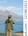Woman looking out over Lake Wakatipu in New Zealand 121861823