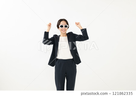 A businesswoman wearing sunglasses and making a fist pump 121862335