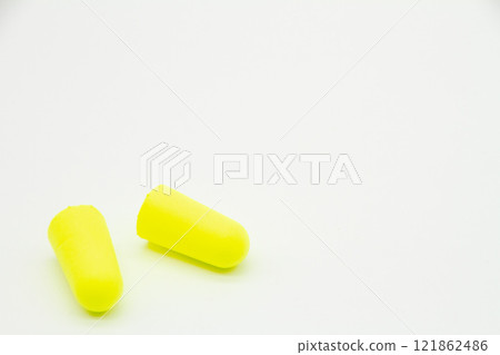 Yellow earplugs on white background Yellow earplugs on white background 121862486