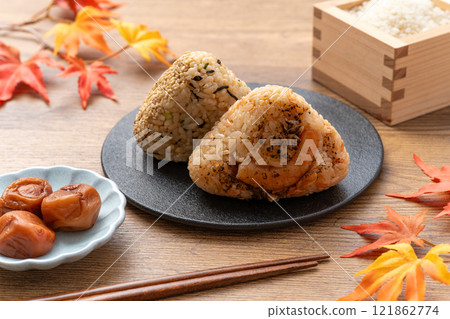 Pickled plums, rice balls and autumn leaves Pickled plums, rice balls and autumn leaves 121862774