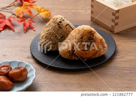 Pickled plums, rice balls and autumn leaves Pickled plums, rice balls and autumn leaves 121862777