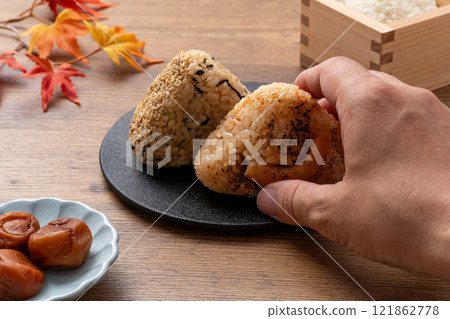Pickled plums, rice balls and autumn leaves Pickled plums, rice balls and autumn leaves 121862778