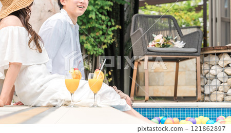 Couples playing by the pool at a resort hotel on vacation 121862897