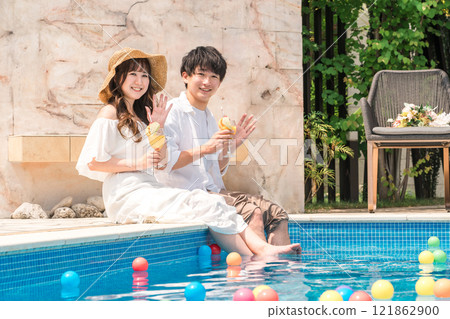 Couples playing by the pool at a resort hotel on vacation 121862900