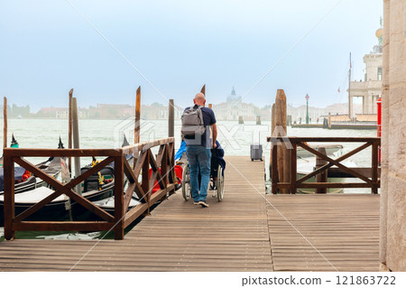 Wooden Dock with Gondolas in Venice, Italy 121863722