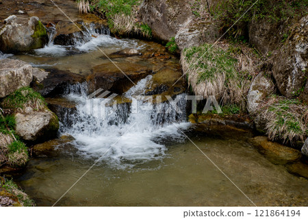Small waterfall in a stream in spring 121864194