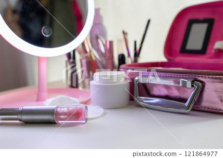 Lip gloss an set of make-up and skin care products .Feminine beauty concept Lip gloss an set of make-up and skin care products .Feminine beauty concept 121864977