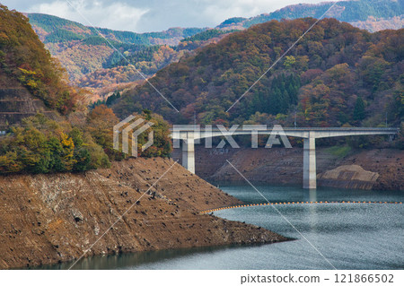 Dam lake and countryside in autumn 121866502