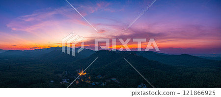 Aerial view of Majestic Buddha on the mountain at colorful sunset. 121866925
