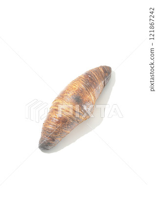 A slightly burnt black wasan photographed against a white background 121867242