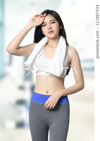 young asian woman in sportwear relax at fitness gym background 121867334