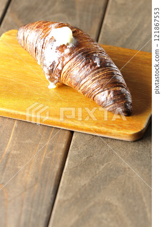 A slightly burnt black wasan on a cutting board 121867553