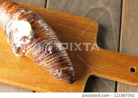 A slightly burnt black wasan on a cutting board 121867562