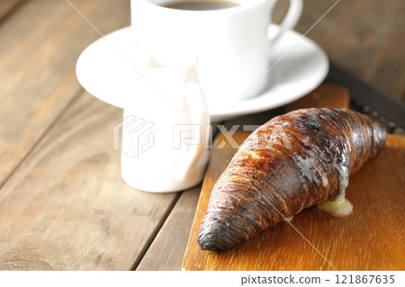 A slightly burnt black wasan sandwich and coffee on a cutting board A slightly burnt black wasan sandwich and coffee on a cutting board 121867635