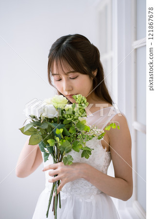A young woman with long black hair wearing a wedding dress A young woman with long black hair wearing a wedding dress 121867678