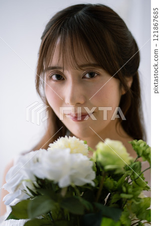 A young woman with long black hair wearing a wedding dress A young woman with long black hair wearing a wedding dress 121867685