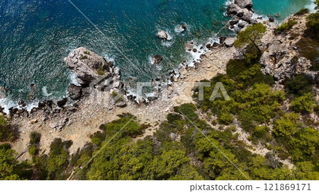 Rocky Shoreline with Turquoise Waters and Greenery Rocky Shoreline with Turquoise Waters and Greenery 121869171