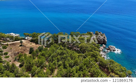Rocky Coastline with Pine Forest and Blue Sea Rocky Coastline with Pine Forest and Blue Sea 121869176