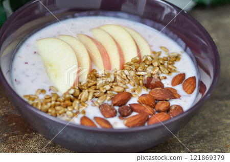 smoothie bowl , strawberry smoothie or strawberry yogurt with apple , sunflower seed and almond 121869379
