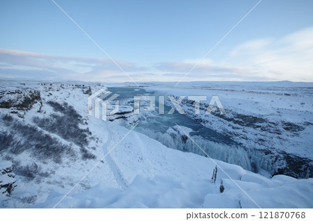 A huge waterfall in Iceland in mid-winter 121870768
