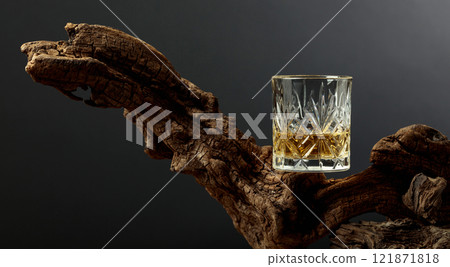 Glass of whiskey on a old snag. Glass of whiskey on a old snag. 121871818