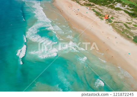 Sandy beach and blue ocean with waves in Brazil, Florianopolis. Aerial view of Campeche beach 121872245