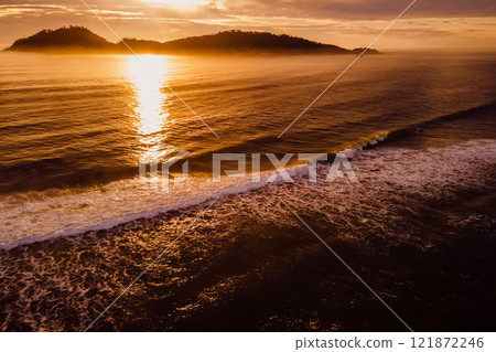 Scenic ocean landscape with sunrise and silhouette of Campeche island in Florianopolis, Brazil 121872246