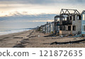 Post-Wildfire Scene of Burned Beachfront Properties and Scorched Landscape 121872635