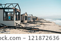 Post-Wildfire Scene of Burned Beachfront Properties and Scorched Landscape 121872636