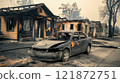 Burnt car and destroyed houses in aftermath of devastating wildfire 121872751