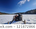 On the shore of a frozen pond. 121872866