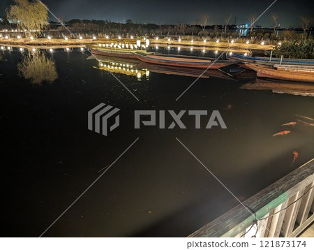 Waterside and boats at night illuminated with Japanese-style illuminations Waterside and boats at night illuminated with Japanese-style illuminations 121873174