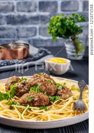 pork burger steak with spaghetti on a plate pork burger steak with spaghetti on a plate 121873588