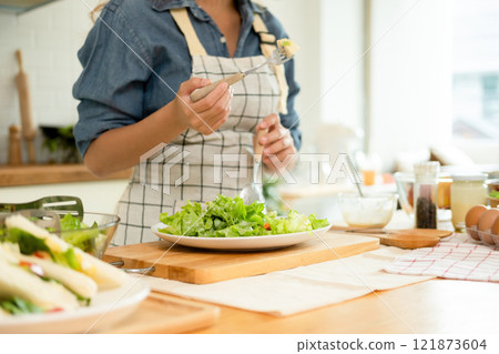 A home-cook eating her own salad A home-cook eating her own salad 121873604