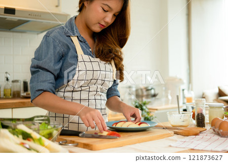 A woman plating her healthy fruit 121873627