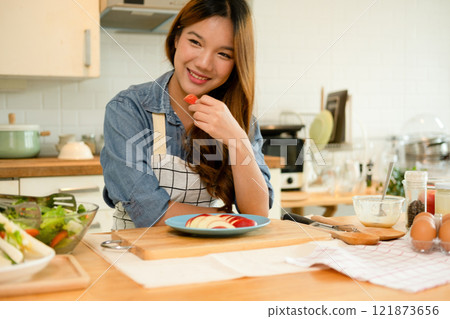A young woman eating an apple A young woman eating an apple 121873656