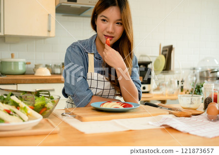 A young woman eating an apple 121873657