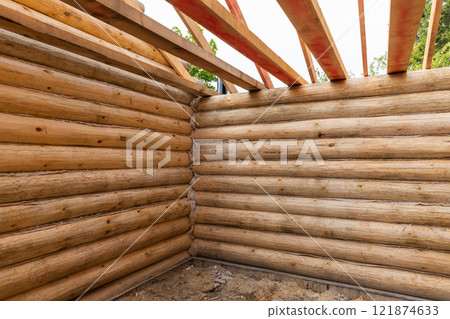 Rural log house is under construction. New wooden house interior 121874633