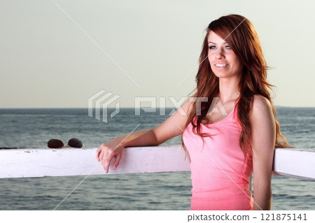 Attractive girl on pier Young woman and sea 121875141