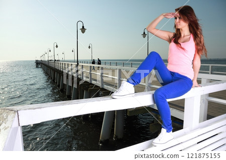 Attractive girl Young woman looking at sea Attractive girl Young woman looking at sea 121875155