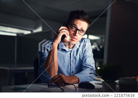 Stressed, overworked and worried while talking on phone to solve problem while working late night at the office. Serious and exhausted man calling IT about computer issue trying to reach deadline Stressed, overworked and worried while talking on phone to solve problem while working late night at the office. Serious and exhausted man calling IT about computer issue trying to reach deadline 121875616