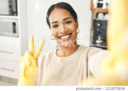 Peace sign, clean and hygienic domestic taking a selfie with a hand gesture at home. Carefree woman enjoying good hygiene while cleaning, doing chores and housework alone expressing happiness. 121875636
