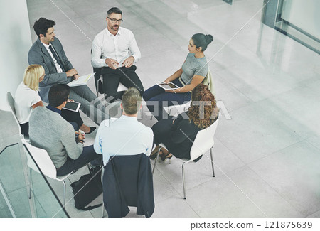 Support, care and unity by colleagues in a business meeting, sitting together in a modern office. Above a creative team brainstorming, planning and sharing an idea or goal while huddled in a circle 121875639