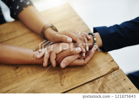 Hands holding abuse victim in a therapy session for support and comfort by a professional psychologist on a wooden table. Kind and caring therapist touching to show care and affection in counseling Hands holding abuse victim in a therapy session for support and comfort by a professional psychologist on a wooden table. Kind and caring therapist touching to show care and affection in counseling 121875643